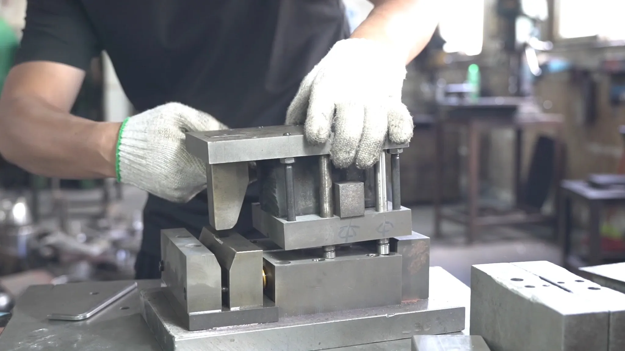 An operator setting a die with fixtures on a press