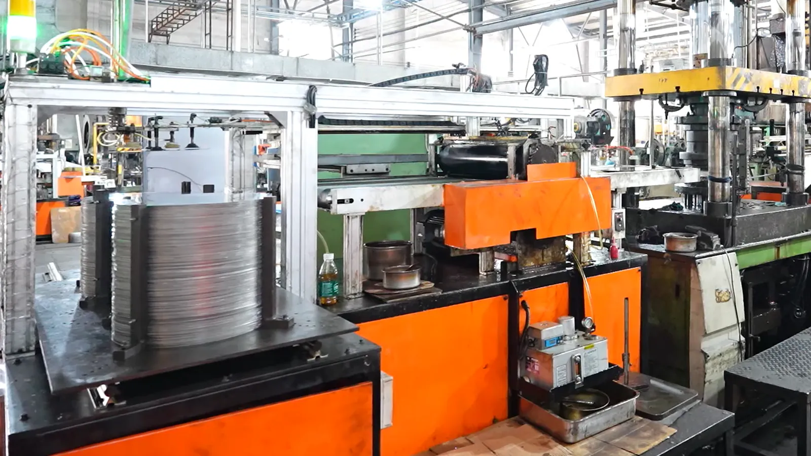 A press line forming stainless steel cookware bodies, the stage after which a mill certificate no longer covers the product